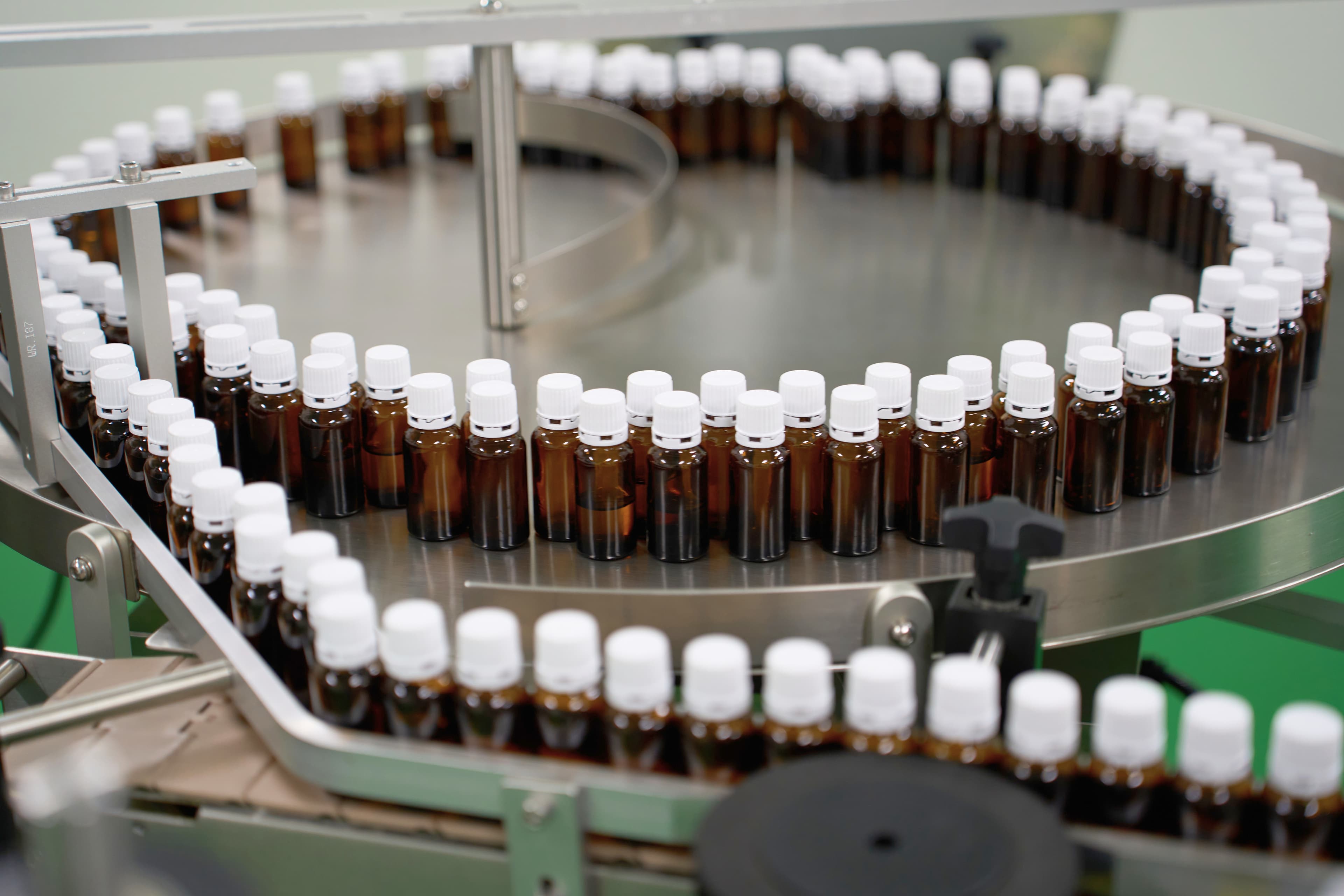Amber glass bottles moving along a production conveyor